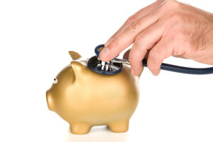 Piggy bank examined with stethoscope